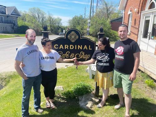 Rob & Nancy Moore hand over the keys to the Cardinal Cafe to new owners, Greg & Christine Butler.